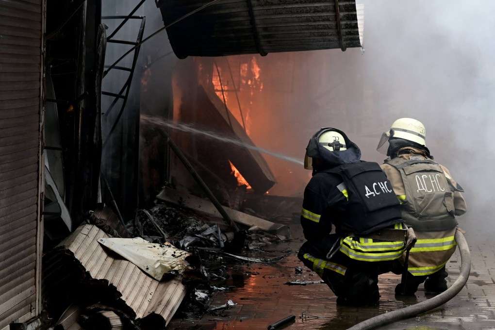 Firefighters work to control flames at the central market of Sloviansk on July 5, 2022, following a suspected missile attack amid the Russian invasion of Ukraine. Photo: AFP