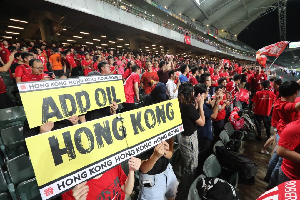 Football fans hold up a sign reading “Add Oil Hong Kong” at the Hong Kong vs Iran 2022 FIFA World Cup qualifying match at Hong Kong Stadium in Happy Valley in September 2019. Photo: Felix Wong
