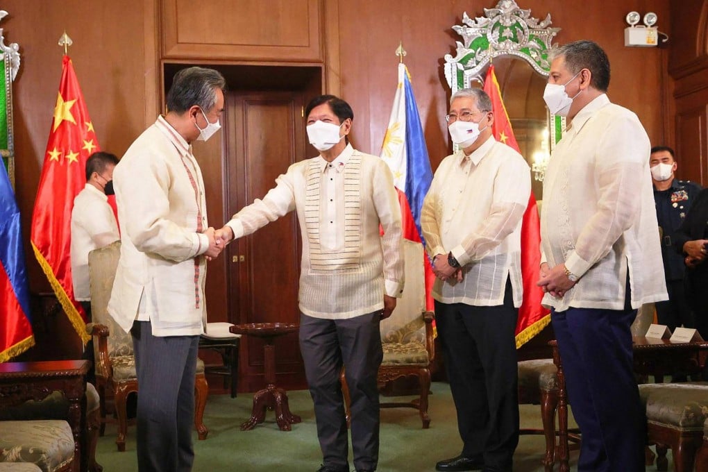 Chinese Foreign Minister Wang Yi (left) greets Philippine President Ferdinand Marcos Jnr in Manila. Photo: AFP