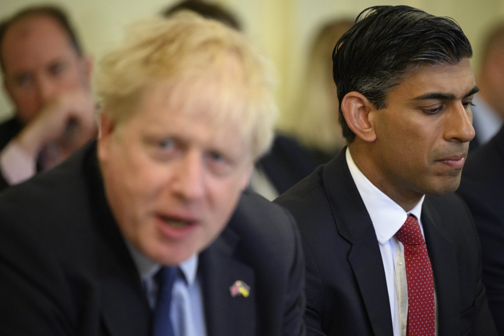 Britain’s Chancellor of the Exchequer Rishi Sunak (right) listens as Prime Minister Boris Johnson addresses his Cabinet in London in June. Photo: AP