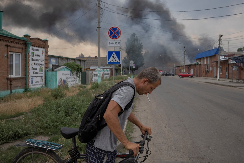 A man pushes a bicycle in Sloviansk, Donetsk region, Ukraine, near a market that was shelled.  Photo: Reuters