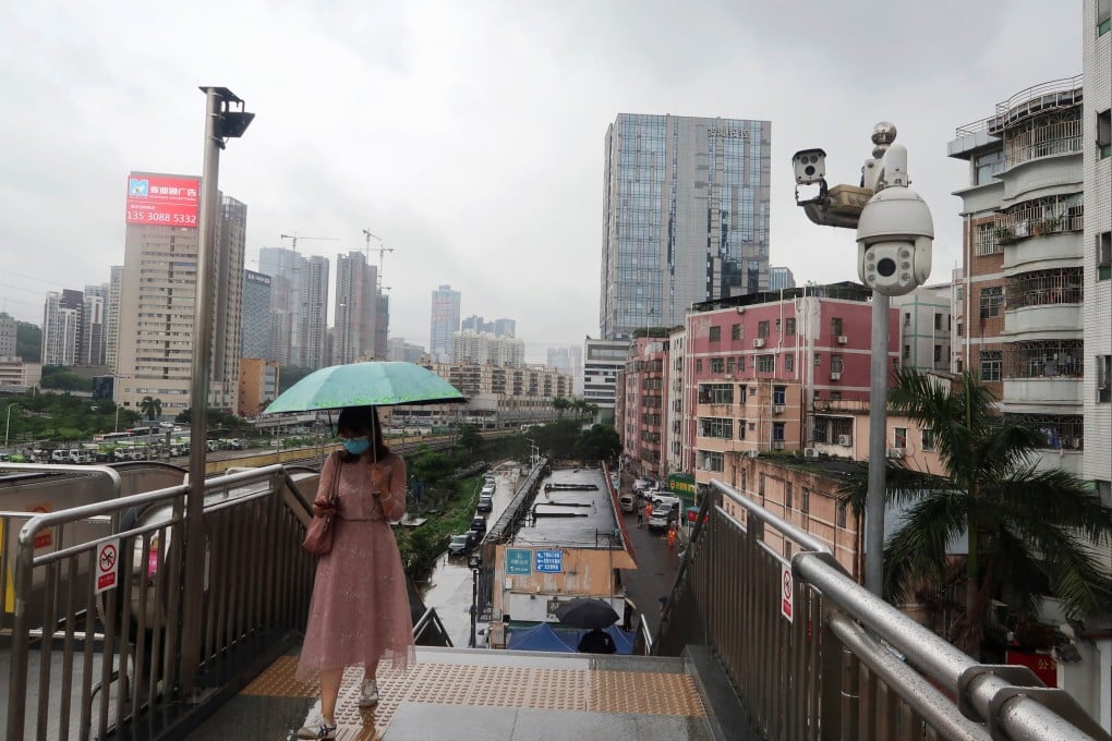 A pedestrian in Shenzhen’s Luohu district. The city has introduced a new series of relief measures to help ailing businesses. Photo: Reuters