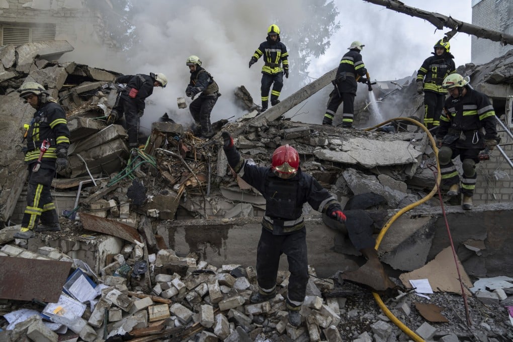 Rescue workers clear rubble of a destroyed school after an attack in Kharkiv, Ukraine, on July 4. Photo: AP