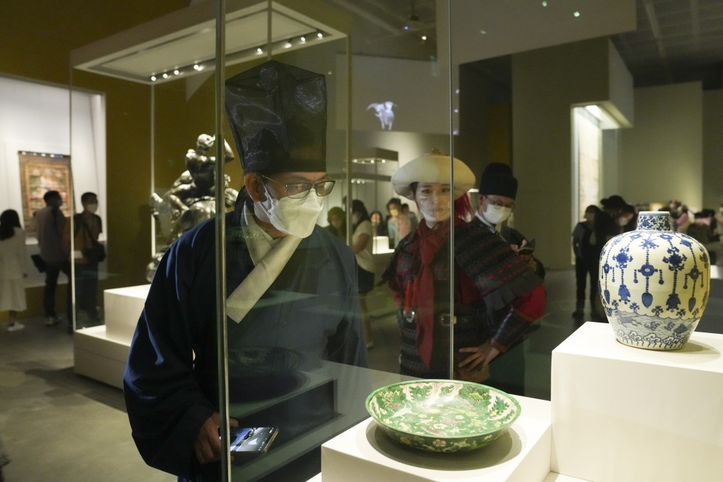 Visitors dress-up in traditional clothing during the opening day of the Hong Kong Palace Museum. Photo: SCMP