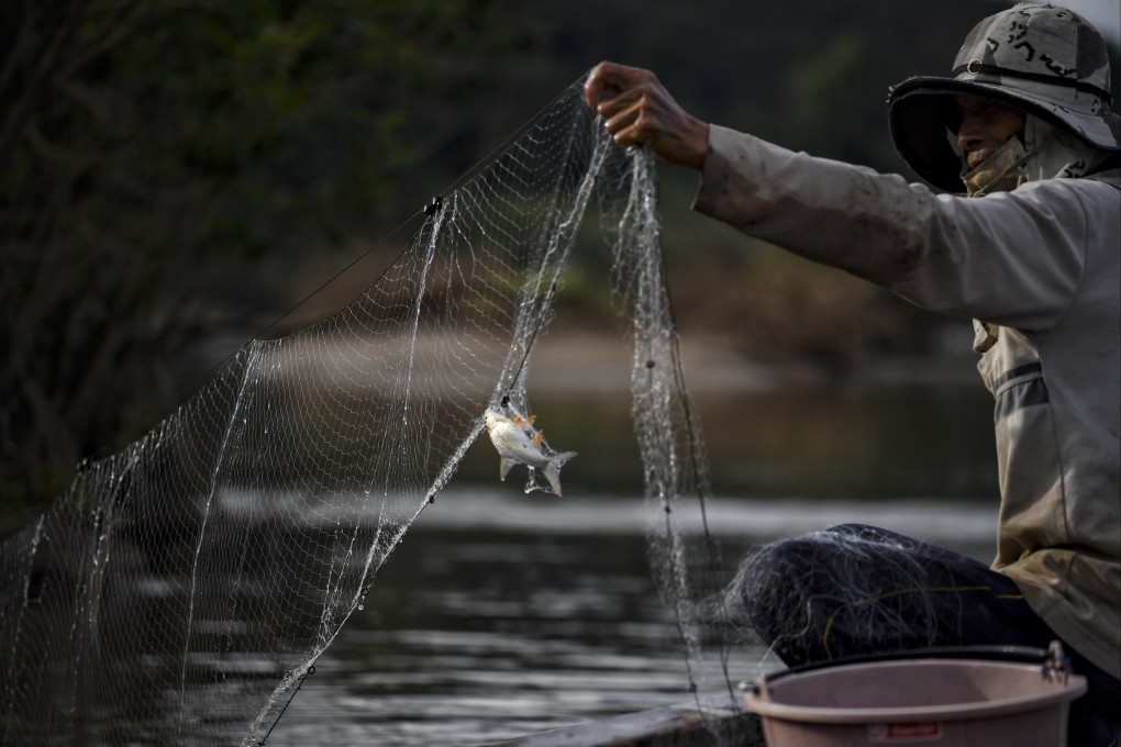 A fisherman checks his net along the Mekong River in the northeastern Thai province of Nong Khai. File photo: AFP