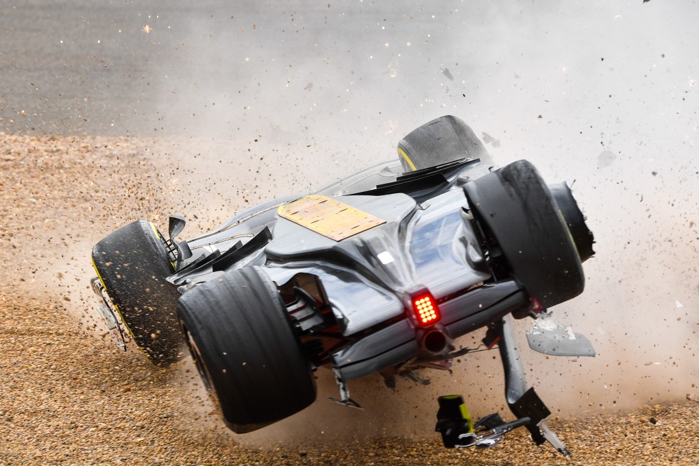 The overturned car of Alfa Romeo’s Chinese driver Zhou Guanyu skids across the track after a crash at the start of the Formula One British Grand Prix at the Silverstone. Photo: Xinhua