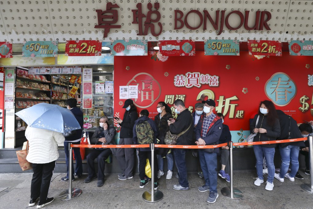 Customers stand in line to purchase protective masks at a Bonjour shop in Hong Kong’s Mong Kok district in February 2020. Photo: SCMP / Nora Tam