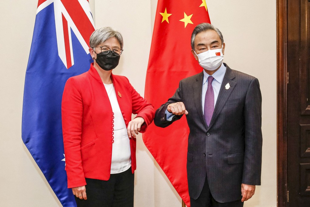 Australia’s Foreign Minister Penny Wong bumps elbows with China’s Foreign Minister Wang Yi in Bali. Photo: AFP