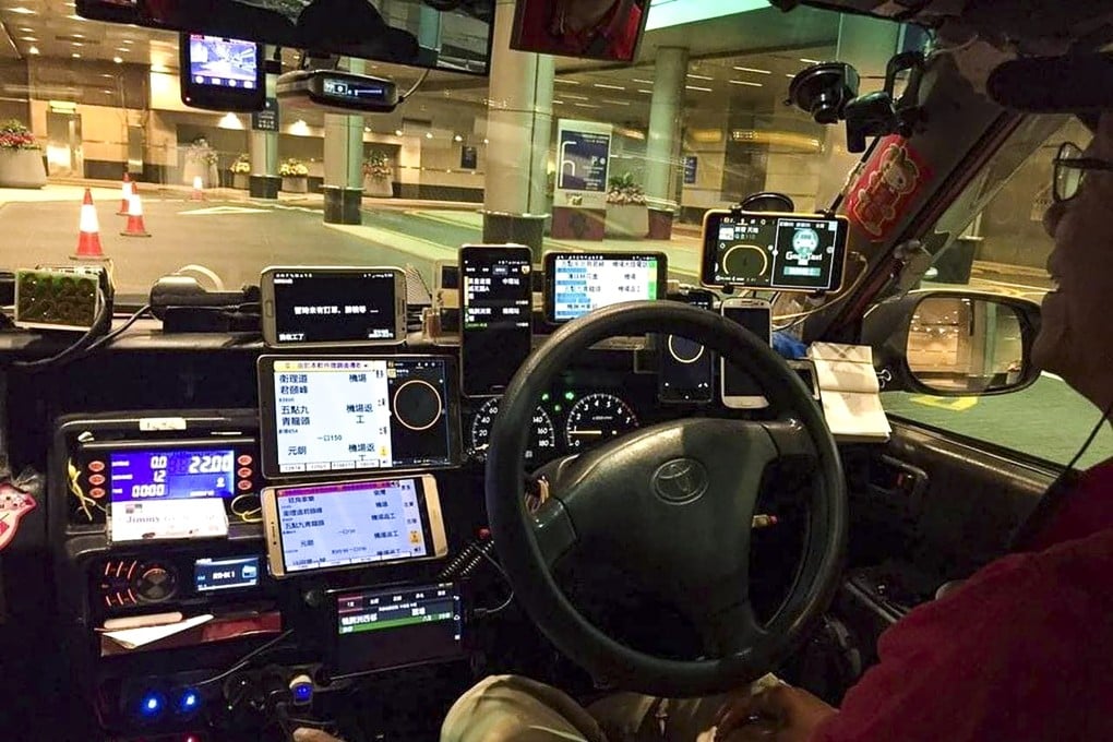 A taxi driver who has lots of phones in his taxi. Hong Kong drivers will face a maximum fine of HK$2,000 if they place more than two phones on the dashboards of their vehicles under a proposal to tighten the safety rules. Photo: Facebook