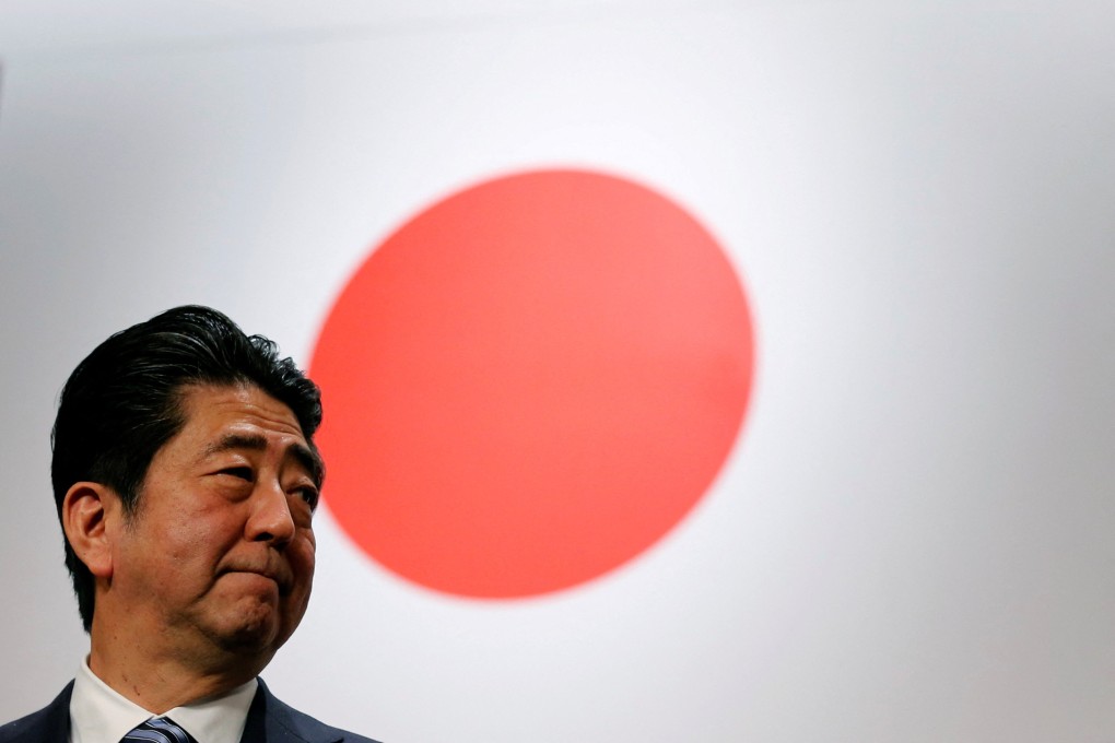 Shinzo Abe, shown in front of Japan’s flag, had bold visions to rejuvenate the country’s stagnant economy and give it a stronger voice. Photo: Reuters