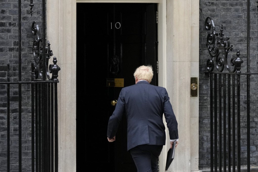 British Prime Minister Boris Johnson walks back inside 10 Downing Street after reading a resignation statement. Photo: AP