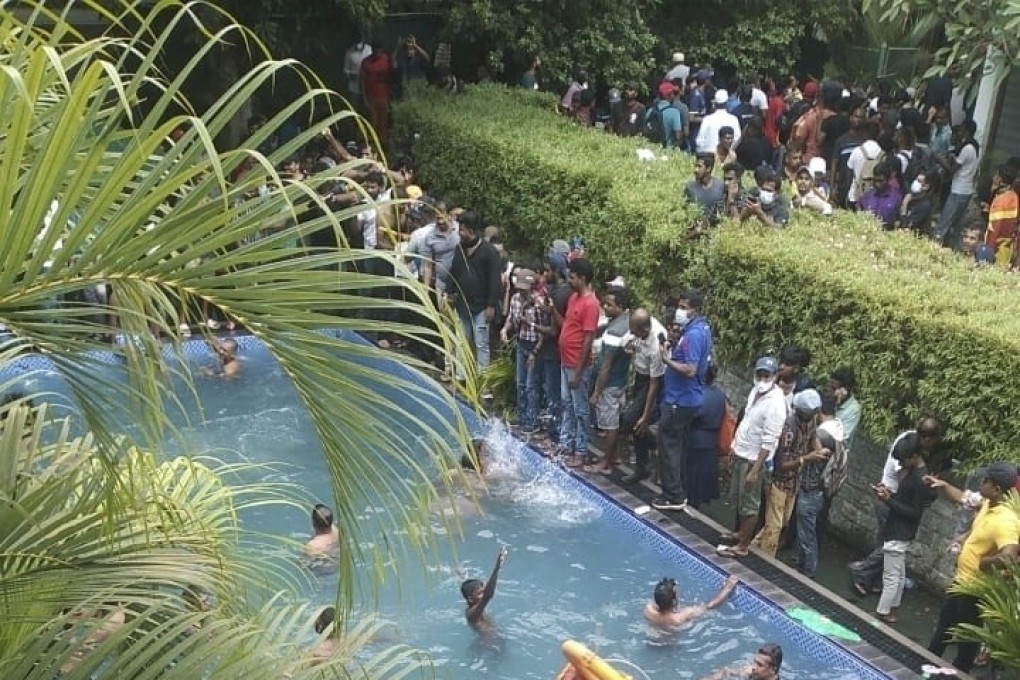Anti-government protesters in Colombo, Sri Lanka, swim in a pool at the president’s official residence after storming in on Saturday. Photo: AP
