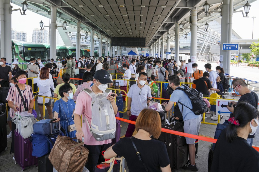 Travellers queue up at the departure hall of Shenzhen Bay Port on Sunday. Photo: Sam Tsang