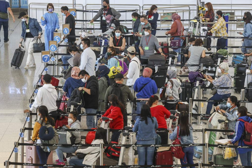 Travellers queue for buses to their quarantine hotels after arriving at Hong Kong International Airport on July 8. Photo: K.Y. Cheng