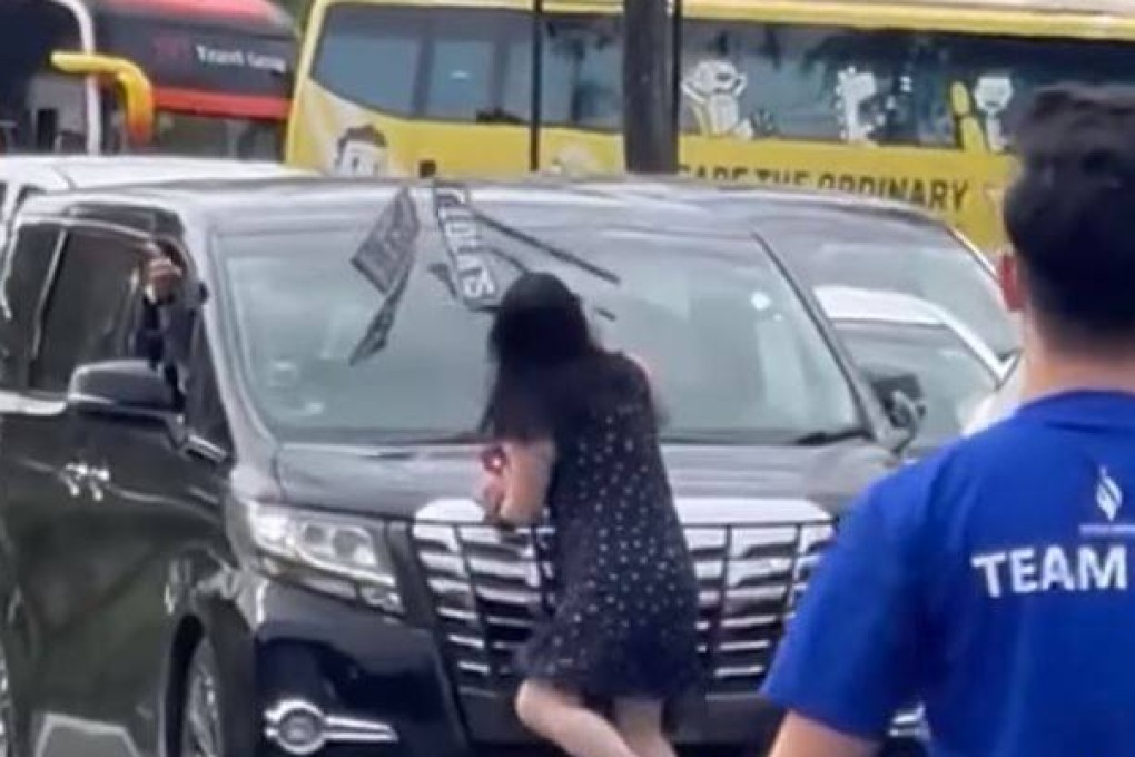 Footage of the Saturday incident on Tuas Second Link showed a woman prying off a number plate with her bare hands before hurling it at the car’s windscreen. Photo: Facebook / SGRVigilante
