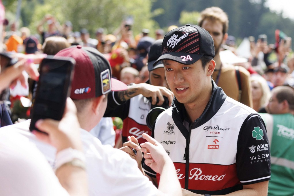 Alfa Romeo driver Zhou Guanyu (R) signs autographs at the Red Bull Ring race track in Spielberg ahead of the Austrian Grand Prix. Photo: AFP
