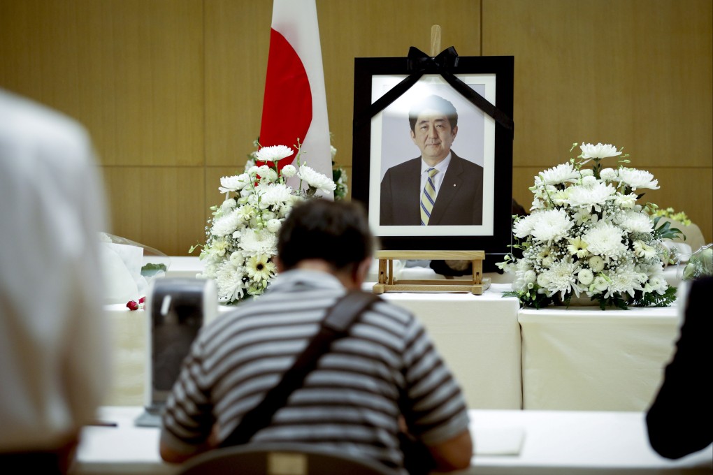 A man signs a book of condolence for former Japanese Prime Minister Shinzo Abe, who was killed on Friday, at the Japanese embassy in Thailand. Photo: EPA-EFE