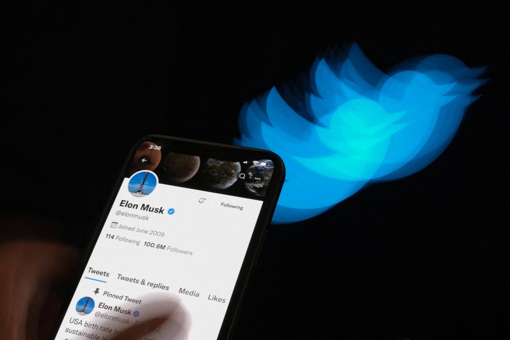 Elon Musk’s Twitter page displayed on a smartphone in front of the Twitter logo on July 8, 2022. Photo: AFP