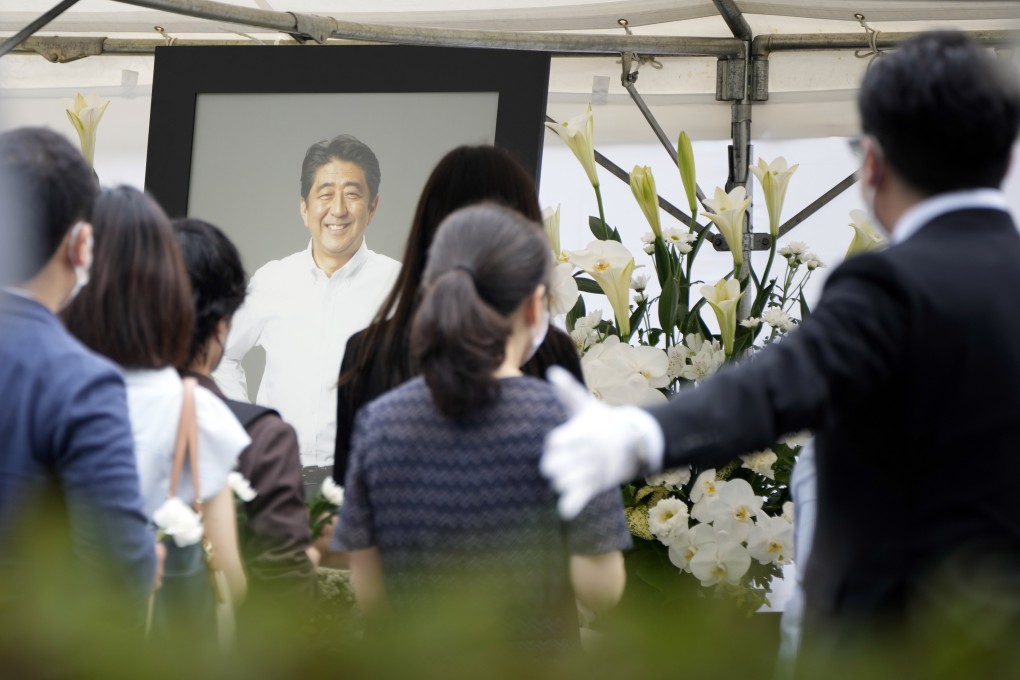 People queue to offer flowers and prayers for Japan’s former Prime Minister Shinzo Abe at Zojoji temple before his funeral on Tuesday. Photo: AP