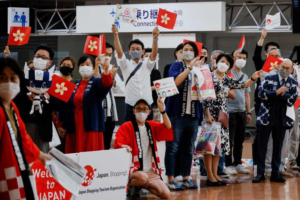 Japanese tourism and retail industry workers greet a group of tourists from Hong Kong upon their arrival in Tokyo last month. Photo: Reuters
