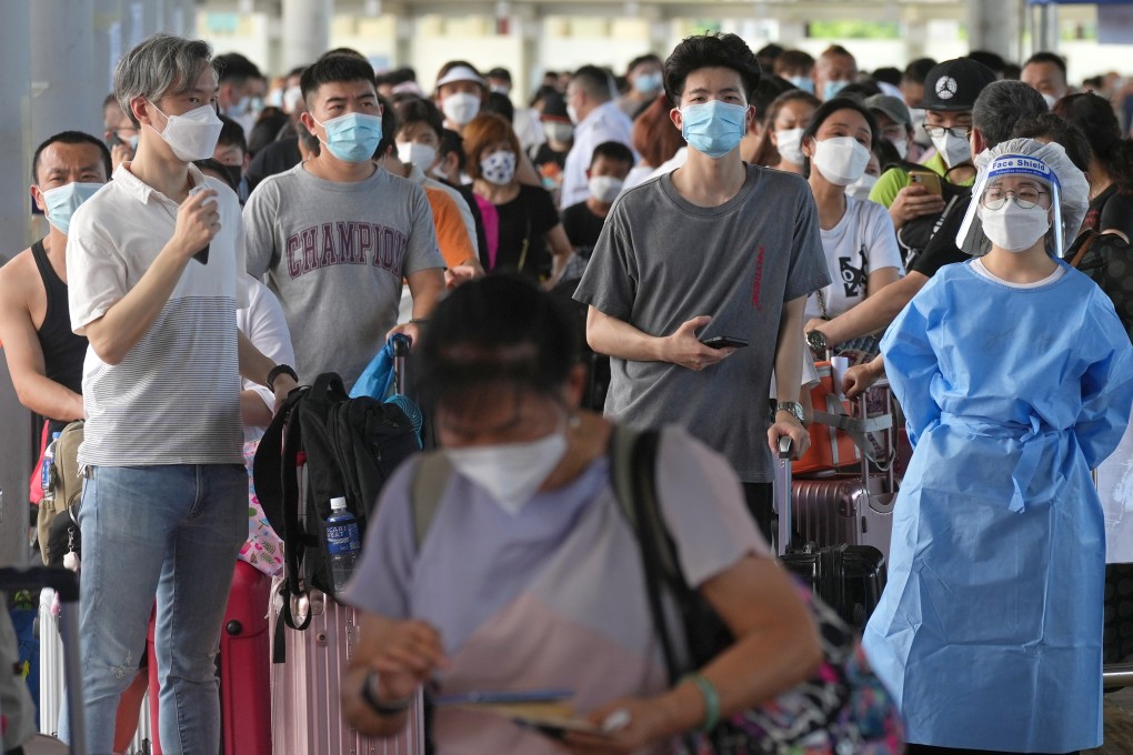 Travellers queue up at the departure hall of Shenzhen Bay Port. Officials warned of rather long waits for Covid-19 tests at the Shenzhen Bay Control Point, urging travellers to avoid going there until later in the day. 10JUL22 SCMP / Sam Tsang
