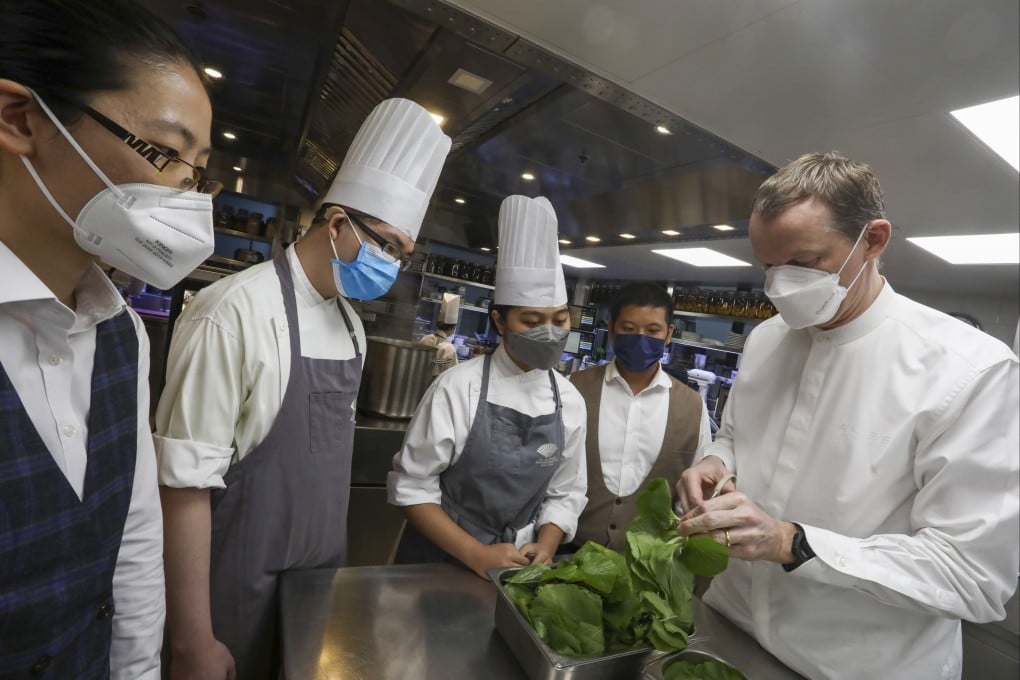 In Hong Kong, people with disabilities are given on-the-job training in real world jobs. Above: interns work with The Landmark Oriental culinary director Richard Ekkebus (right). Photo: Jonathan Wong