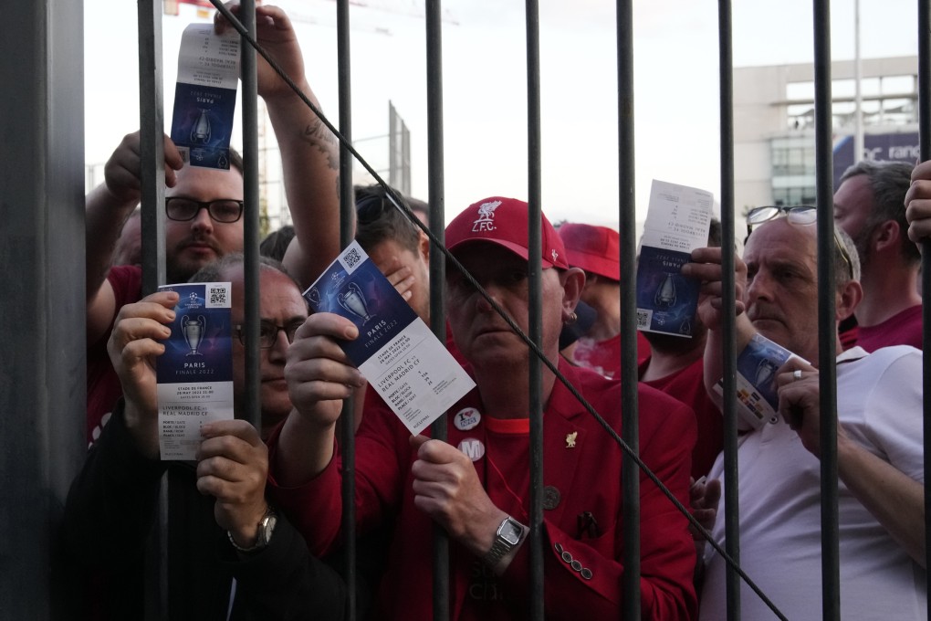 Liverpool fans show tickets and wait in front of the Stade de France before the Champions League final between Liverpool and Real Madrid. Photo: AP