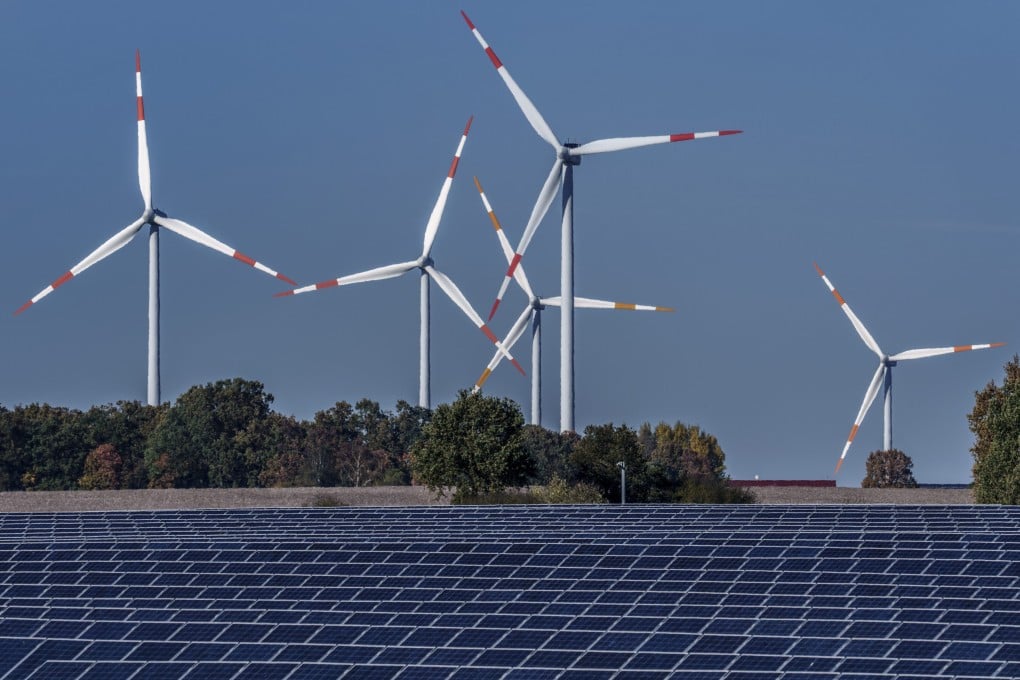 Wind turbines are seen behind a solar farm in Rapshagen, Germany. Renewable energy’s importance is being increasingly underscored by the fight against climate change. Photo: AP