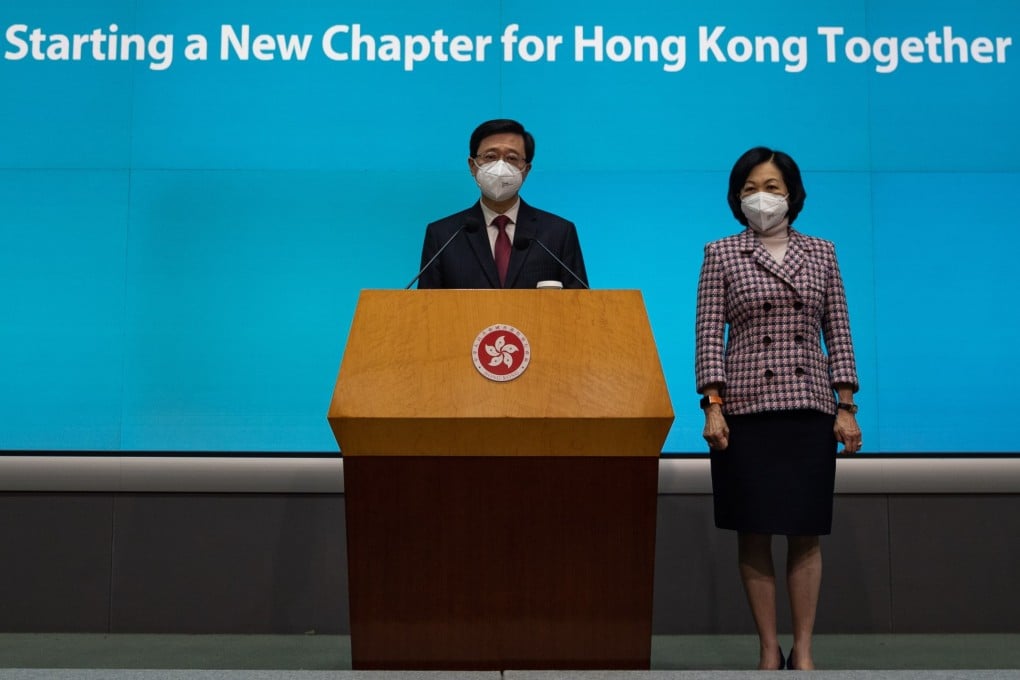 Chief Executive John Lee, flanked by Executive Council convenor Regina Ip Lau Suk-yee, speaks to the media on July 5. Photo: EPA-EFE