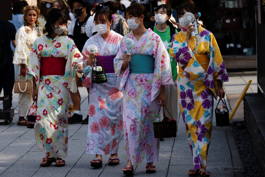 Women wearing summer kimonos use portable fans as they walk in the Asakusa district of Tokyo on June 29. Japan’s investigation of the weight and dietary habits of young women is tainted by its framing as a matter of ensuring healthy babies. Photo: Reuters