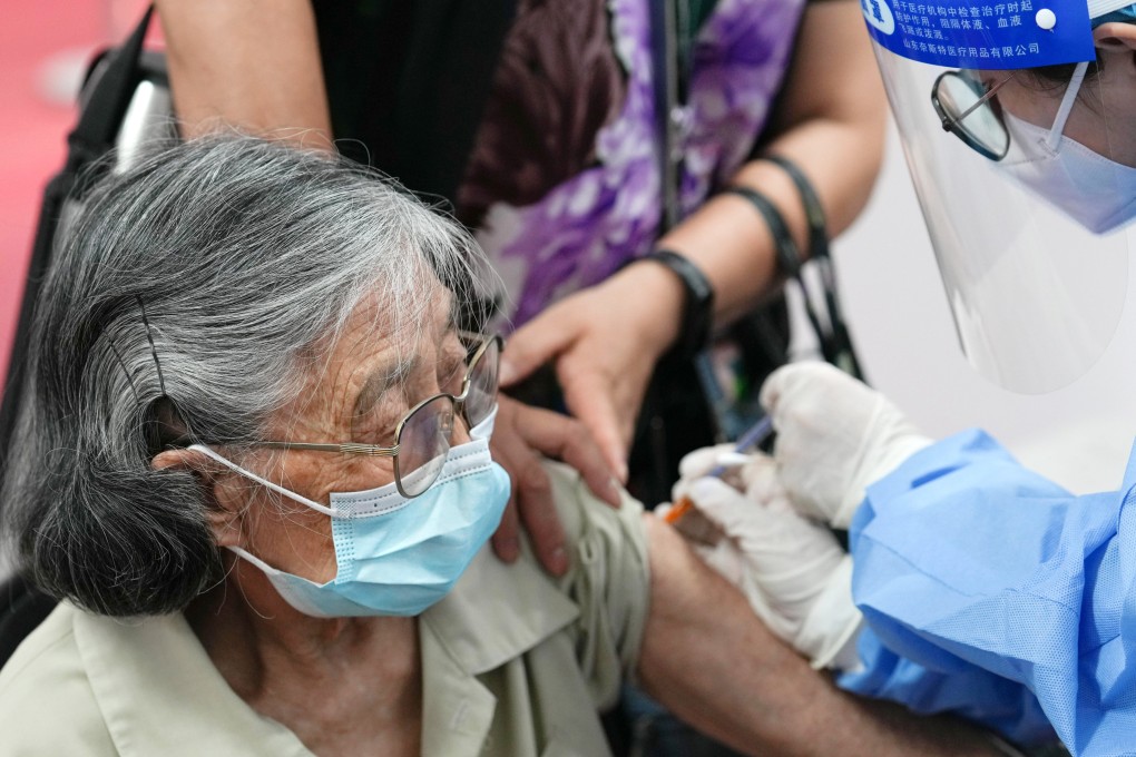 An 89-year-old woman receives a Covid-19 vaccine booster shot at a clinic in Beijing. Many of China’s old people haven’t received any vaccine doses at all. Photo: Xinhua