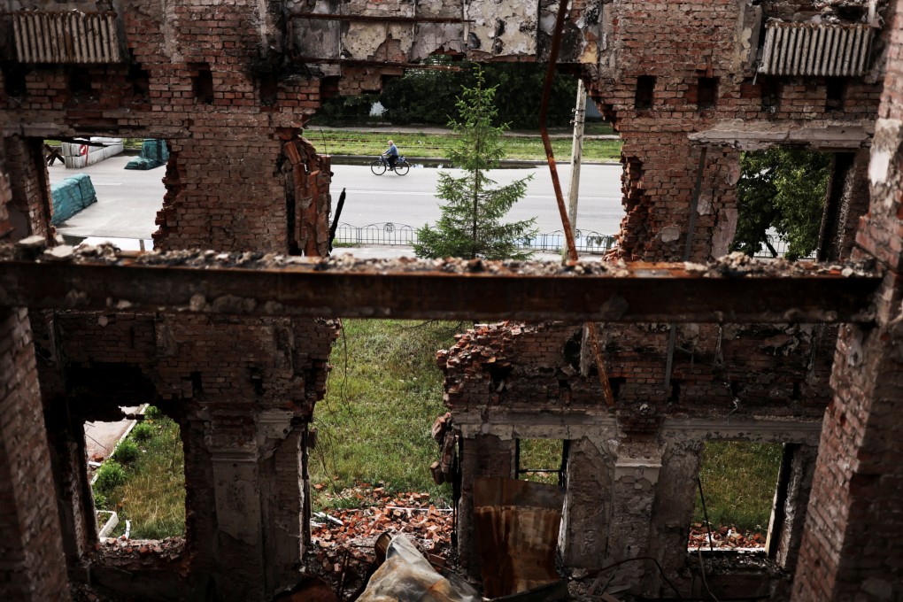 A man rides his bicycle in front of a school that was destroyed during a Russian attack in Kharkiv, Ukraine, on July 14. Photo: Reuters