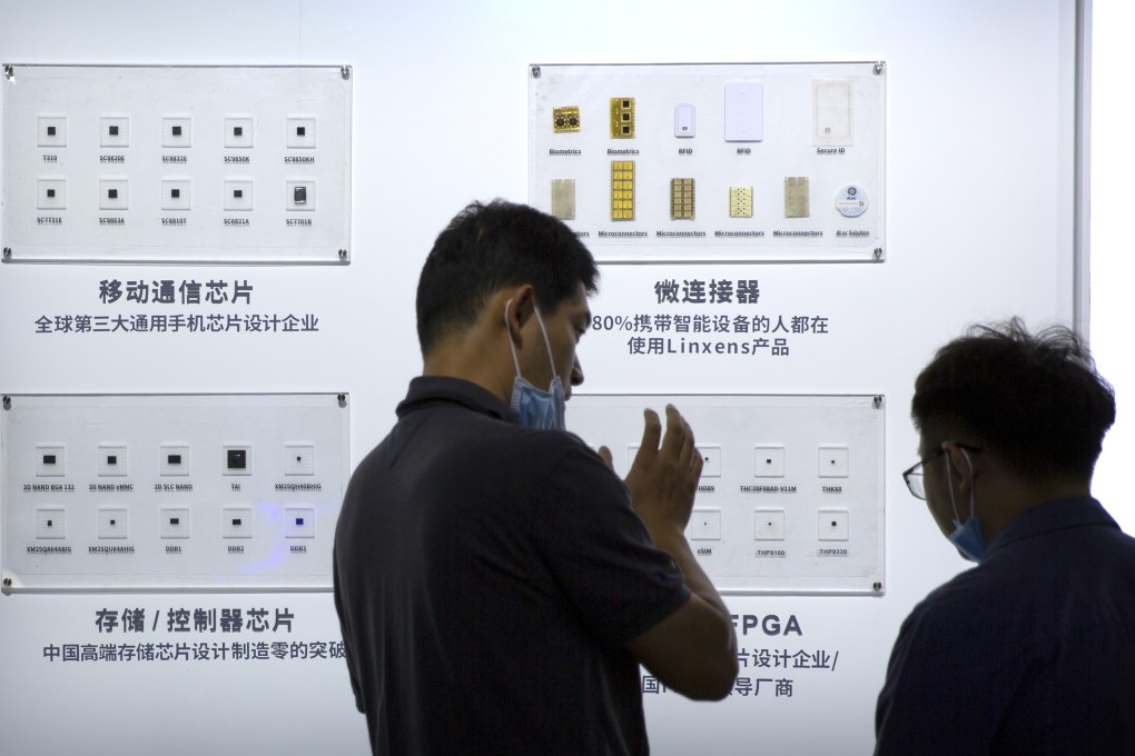 People look at a display of semiconductor products from Tsinghua Unigroup in Beijing in 2020. Photo: AP