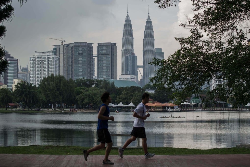 People jog in a park in Kuala Lumpur, Malaysia. The heirs of a 19th century sultan are seeking to seize Malaysian government assets around the world. File photo: AFP