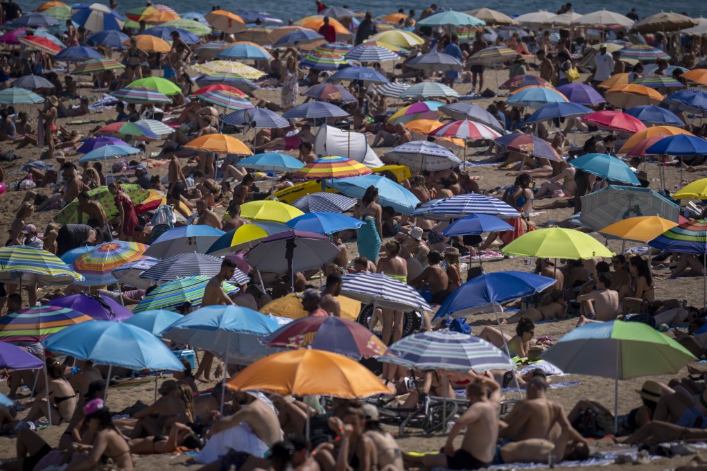 A packed beach in Barcelona, Spain, as temperatures reach record levels across Europe. Photo: AP