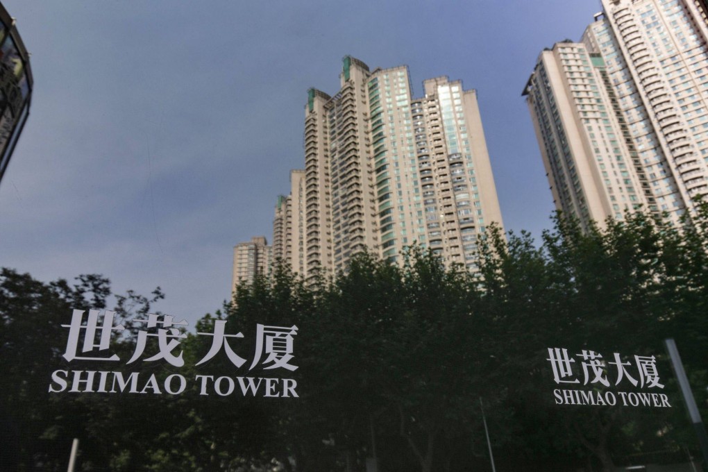 The Riviera Garden residential property, developed by Shimao Group Holdings, reflected in a window at Shimao Tower in Shanghai on July 14, 2022. The company is one among many Chinese property developers that have missed bond payments this year. Photo: Bloomberg