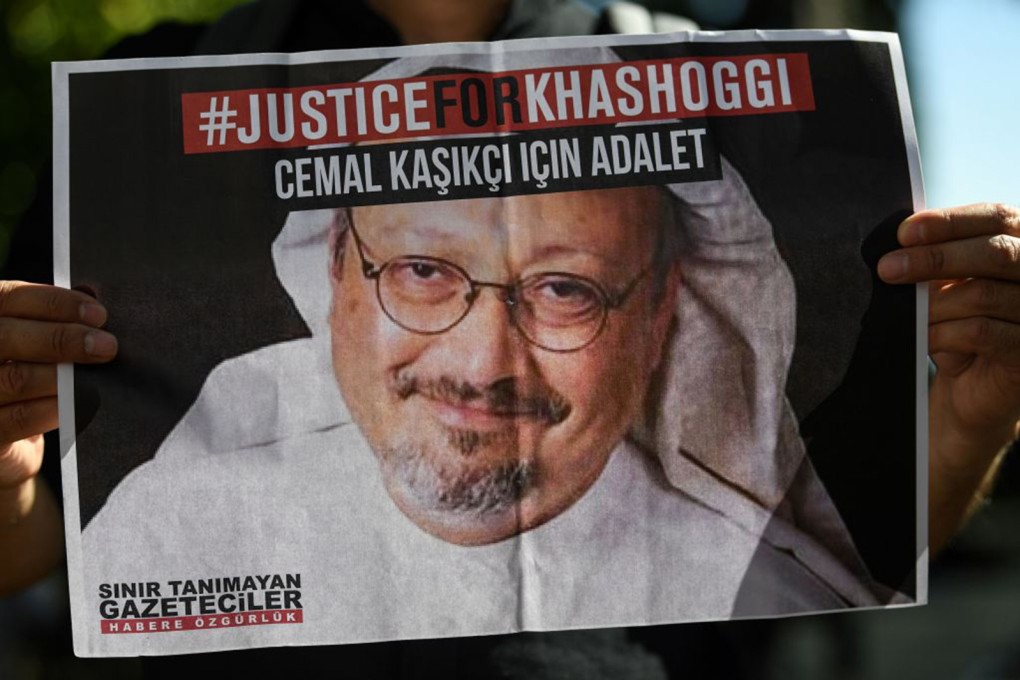 Friends of murdered Saudi journalist Jamal Khashoggi hold posters bearing his picture as they attend an event marking the anniversary of his assassination. Photo: AFP