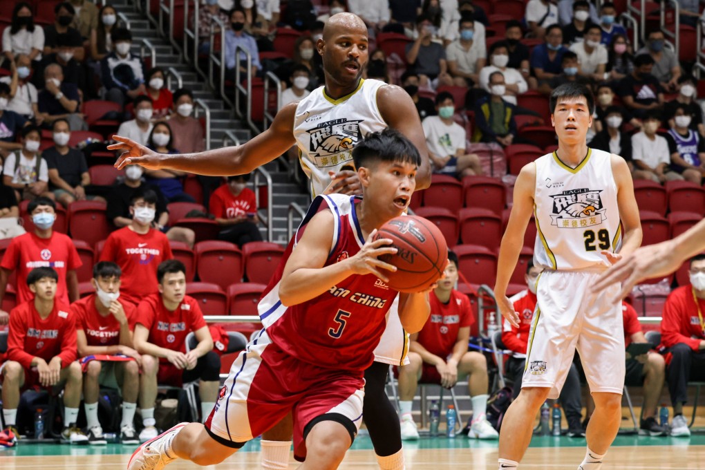 Nam Ching guard Cheng Hoi-on (red) gets past Bryant Austin of Sheung Tak Alumni Eagle at Southorn Stadium. Photo: K. Y. Cheng