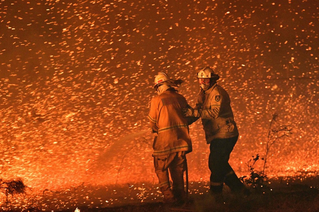 Australian firefighters struggle to bring a bush fire under control in 2019 near the town of Nowra, New South Wales. Photo: AFP