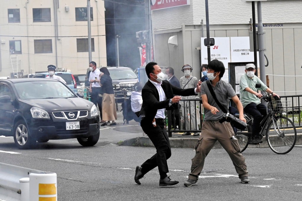 A police officer detains the man who shot Shinzo Abe in Nara on July 8. Analysts said the priority should have been shielding or moving the former Japanese prime minister. Photo: The Asahi Newspaper via Reuters