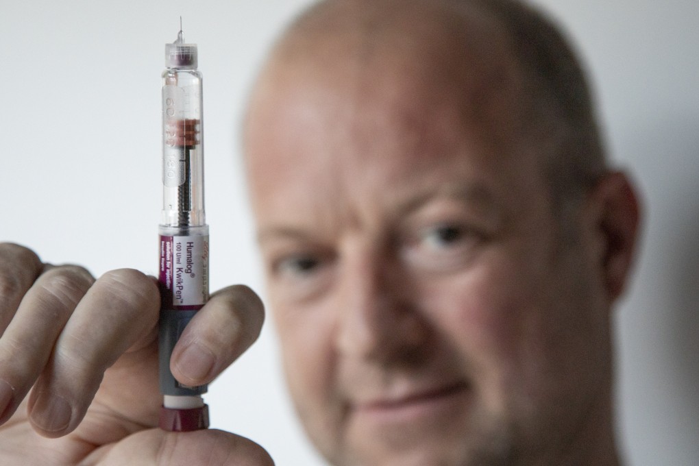 Simon O’Reilly, a production editor at the South China Morning Post, holds a Humalog KwikPen, a pre-filled fast-acting insulin pen used to treat diabetes. The type 1 diabetic recently injected four times too much of this insulin, which saw him rushed to hospital. Photo: Antony Dickson