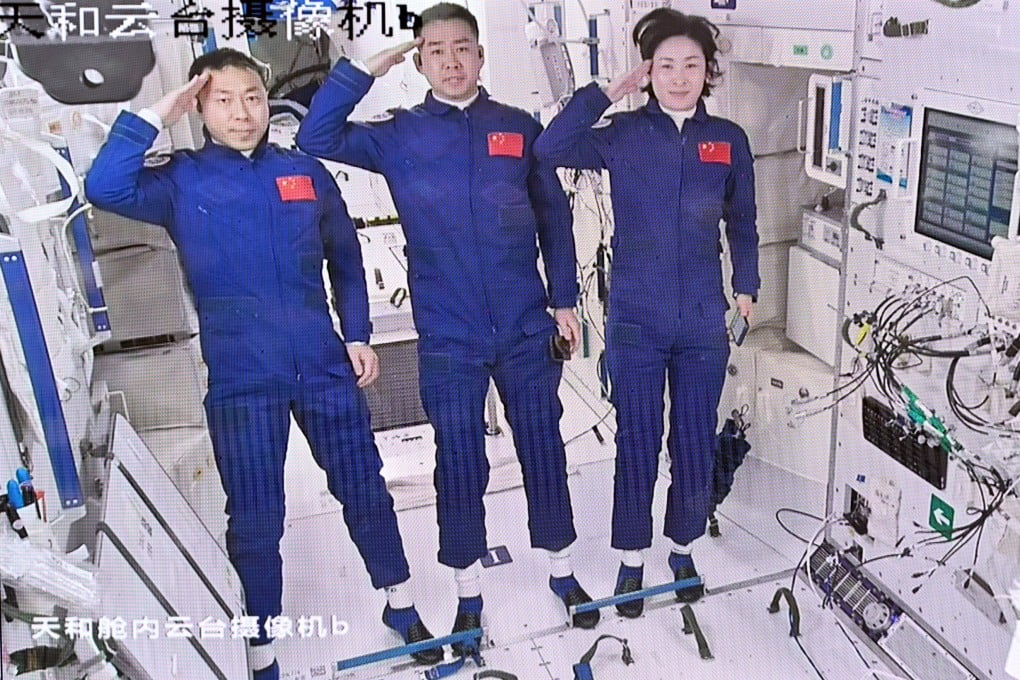 Astronauts (from left) Cai Xuzhe, Chen Dong and Liu Yang salute after entering the Chinese space station in June. Space engineers are working on an exoskeleton suit for astronauts. Photo: Xinhua