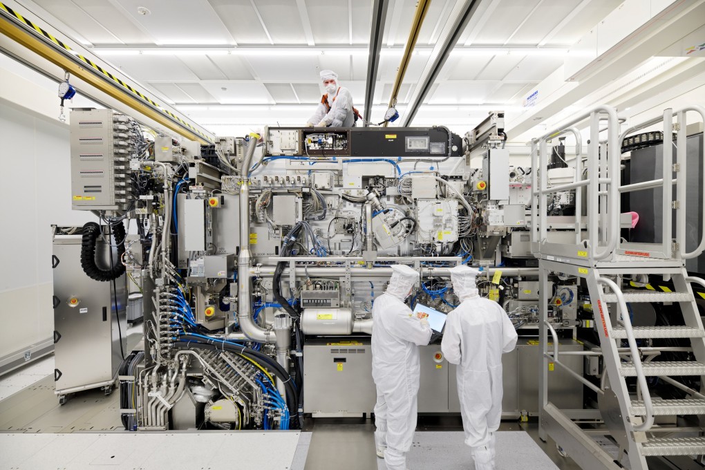 Employees are seen working on the final assembly of an ASML semiconductor lithography machine. Photo: Reuters