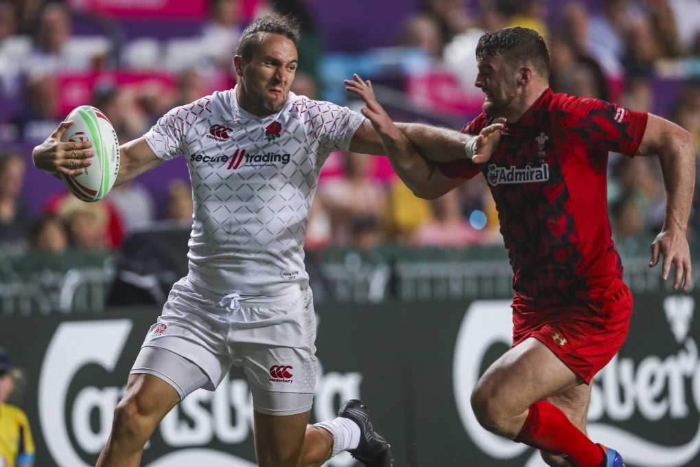 Mike Ellery of England fends off an opponent during a game against Wales on the first day of the 2019 Hong Kong Sevens at Hong Kong Stadium. Photo: Winson Wong