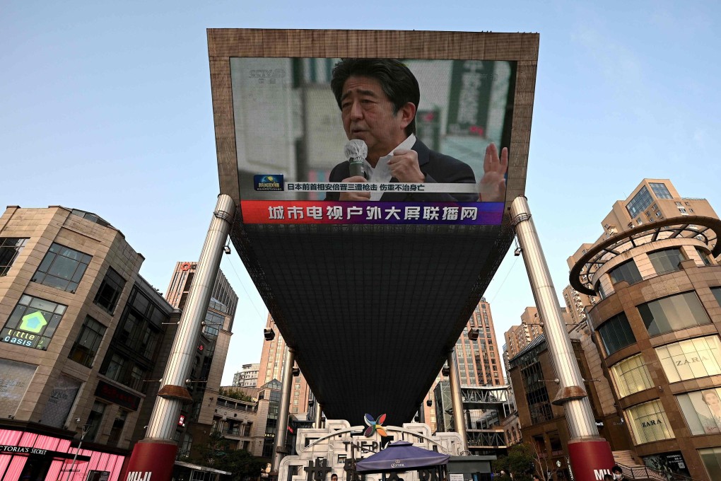 A large video screen shows news broadcast featuring an image of former Japanese prime minister Shinzo Abe in Beijing on July 8. Online, some Chinese netizens were delighted with Abe’s assassination. Photo: AFP