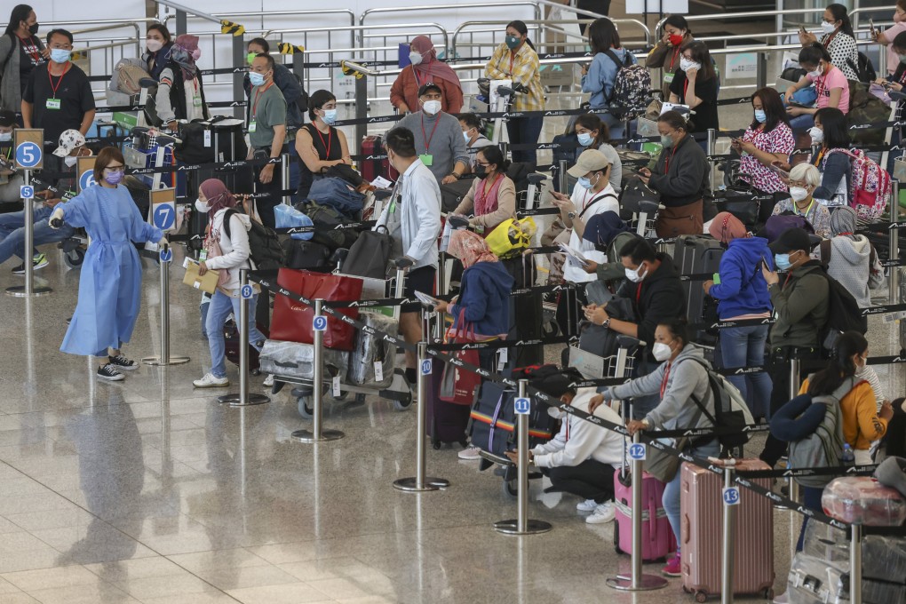 Travellers queue for buses to their quarantine hotels after arriving at Hong Kong International Airport on July 8. Photo: K.Y. Cheng