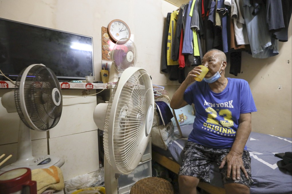 Suen Shau-shing, 78, living in a subdivided unit in Sham Shui Po, uses three fans to try and cool down his flat. Photo: Yik Yeung-man
