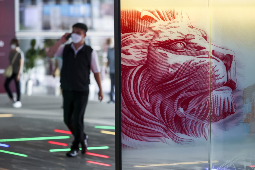 A pedestrian walks underneath the atrium at HSBC’s main building in Central. Photo: Nora Tam