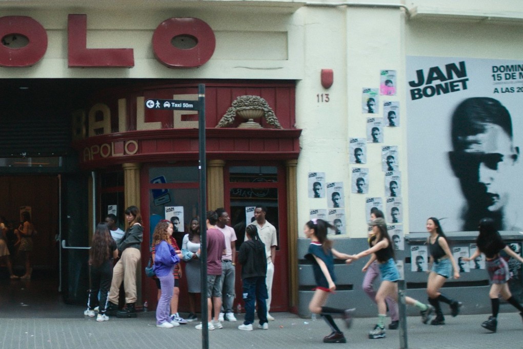 Members of rookie K-pop girl group NewJeans (above right) run towards a theatre entrance in a promotional photo released for the launch of their debut track and music video, Attention, on July 22. Photo: Ador