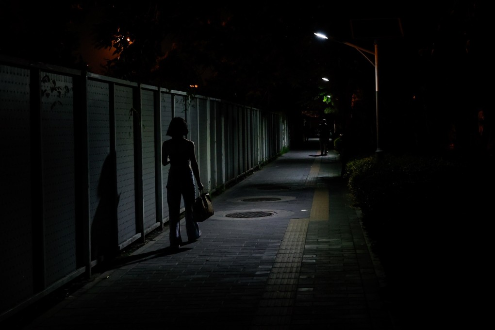 A woman walks along an alley in Beijing on July 8. A video of men attacking four women at a restaurant in Tangshan, Hebei province, in June has caused public outrage and raised awareness of the need for women’s safety. Photo: EPA-EFE
